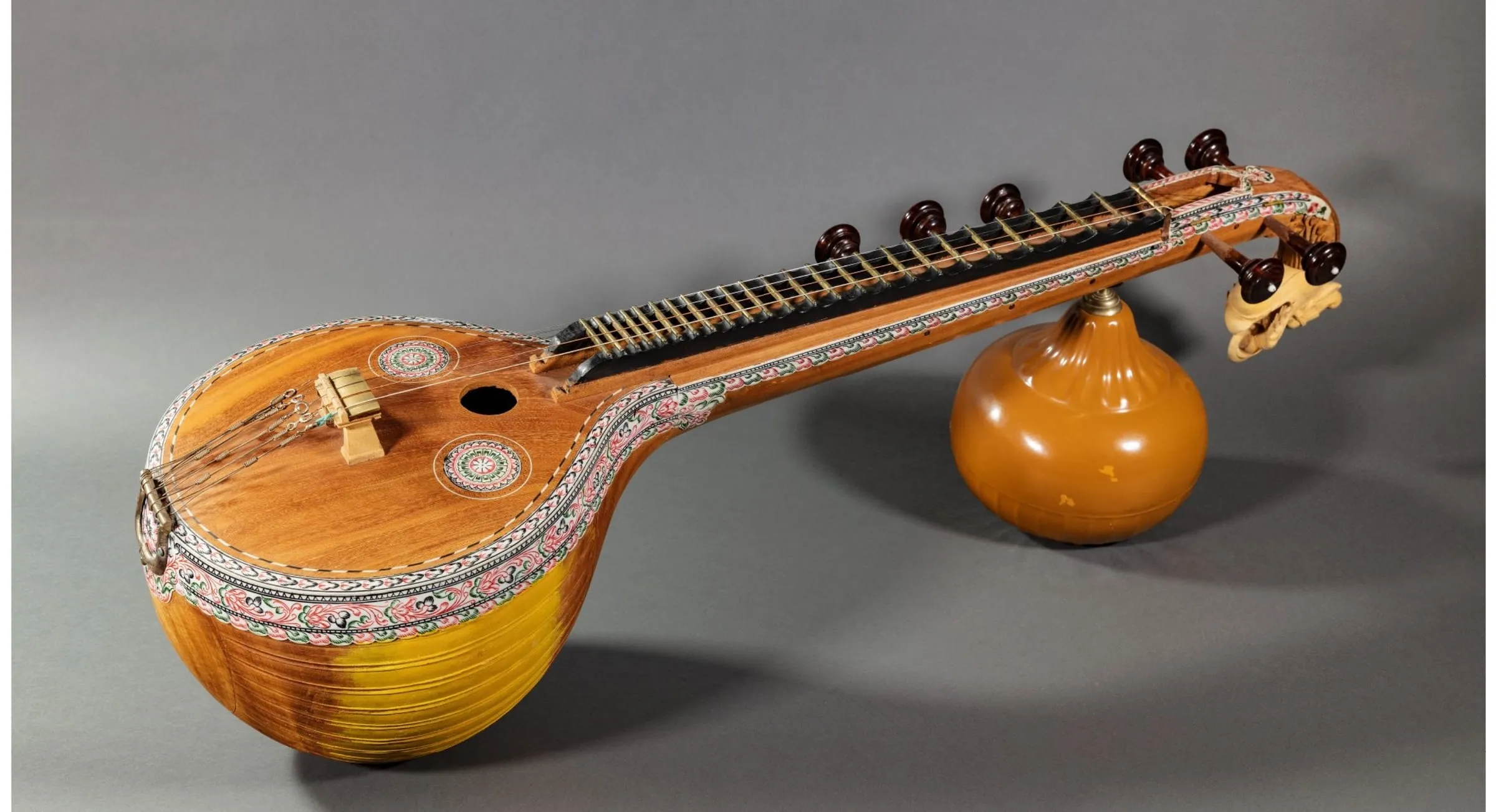 A Saraswati veena: carved wooden body, long fretted neck and a gourd resonator